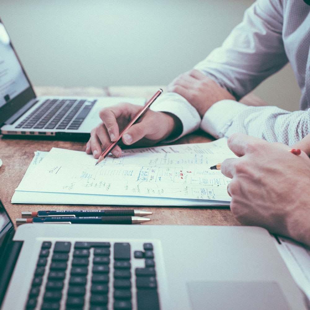 Two people looking over paperwork together